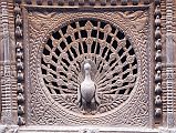 Kathmandu Bhaktapur 09 Peacock Window The 15C peacock window near Pujari Math in Bhaktapur is reputed to be the finest carved window in the Kathmandu Valley.  I went to the upper floor window of the shop opposite to get a better photo.